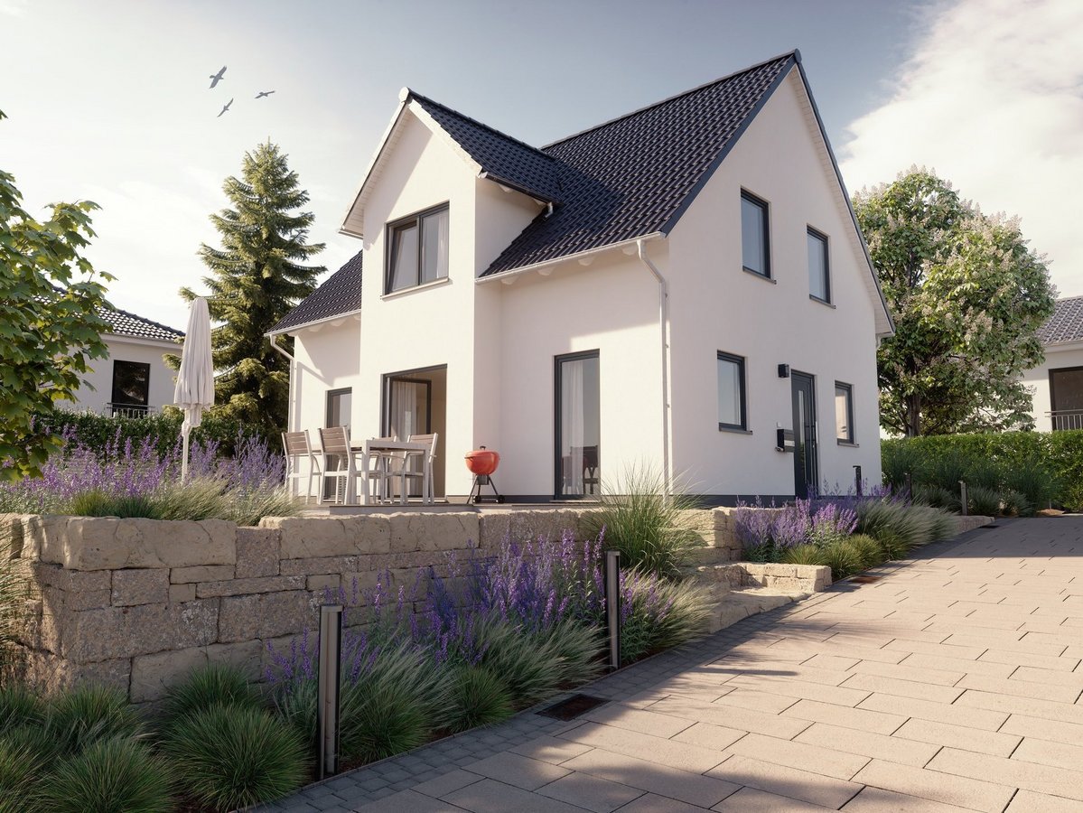 Modernes Einfamilienhaus mit Satteldach, heller Fassade, Vorgarten und gepflasterter Zufahrt